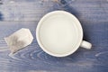 Cup or white mug with transparent hot water and bag of tea. Tea time concept. Mug filled with boiling water and teabag Royalty Free Stock Photo