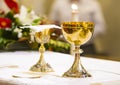 Cup with wine and ciborium with host on the altar of the holy mass Royalty Free Stock Photo