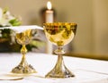 Cup with wine and ciborium with host on the altar of the holy mass Royalty Free Stock Photo