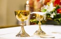 Cup with wine and ciborium with host on the altar of the holy mass