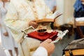 Cup of wine in the hands of a priest in a church