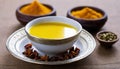 A cup of yellow liquid with spices on the side Royalty Free Stock Photo