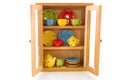 Cupboard with cheerful crockery Royalty Free Stock Photo
