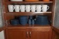 Cupboard interior with neat row of cups