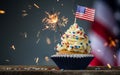 Cupcake and American Flag. Sparklers or fireworks lights burning in a cake. 4th of July, Independence, Presidents Day. Tasty cupca Royalty Free Stock Photo