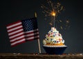 Cupcake and American Flag. 4th of July, Independence, Memorial or Presidents Day. Tasty cupcakes with white cream icing and colore Royalty Free Stock Photo