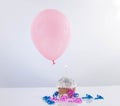 Cupcake with balloon on white background