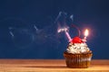 Cupcake with blown out burning candles