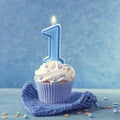 Cupcake with a blue candle Royalty Free Stock Photo