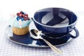 Cupcake and blue cup Royalty Free Stock Photo