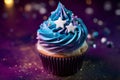 Cupcake with blue and purple and purple galaxy frosting with stars and sugar sprinkles