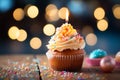 Cupcake with candle, birthday delight, bokeh lights backdrop, festive