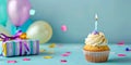 A cupcake with a candle on top of a gift box Royalty Free Stock Photo
