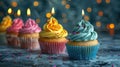 Cupcake Celebration with Bokeh Lights: Colorful Row of Candles and Sweets Royalty Free Stock Photo