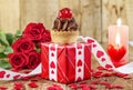 Cupcake with cherry over red gift box Royalty Free Stock Photo