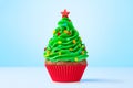 Cupcake. Christmas Tree cupcake with star on top. Red cup liners. Merry Christmas. Tasty baking cupcakes, cake or muffin Royalty Free Stock Photo