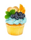 Cupcake with cookies, fresh blueberries, mint and slices of orange Royalty Free Stock Photo