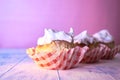 Cupcake with cream on a pastel background on a wooden table Royalty Free Stock Photo
