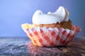 Cupcake with cream on a pastel background on a wooden table Royalty Free Stock Photo