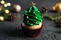 Cupcake decorated with creamy Christmas tree on dark table, closeup Royalty Free Stock Photo