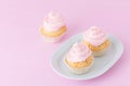 Cupcake decorated with pink and violet buttercream on pastel pink background. Sweet beautiful cake. Horizontal banner, greeting ca Royalty Free Stock Photo