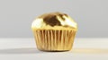 Golden Cupcake with Metallic Shine on White Background Royalty Free Stock Photo