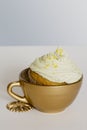 Cupcake with frosting and sprinkles, in golden cup Royalty Free Stock Photo