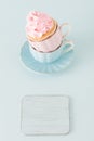 Cupcake with gentle pink cream decoration in two cups on blue pastel background. Royalty Free Stock Photo