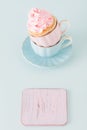 Cupcake with gentle pink cream decoration in two cups on blue pastel background. Royalty Free Stock Photo