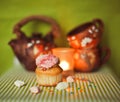 Cupcake on green background with tea pot and cups Royalty Free Stock Photo