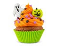 Cupcake on Halloween. Carved pumpkin. Jack o lantern. Dessert on Halloween party. Muffin decorated with colored sprinkles Royalty Free Stock Photo