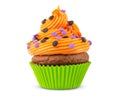 Cupcake on Halloween. Dessert on Halloween party. Muffin decorated with colored sprinkles, candy, orange frosting and Icing Royalty Free Stock Photo