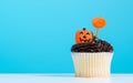 Cupcake on Halloween party. Dessert decorated with chocolate cream, candy shaped pumpkin Jack-o-lantern frosting or Icing. Cupcake Royalty Free Stock Photo