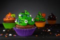 Cupcake on Halloween. Pumpkin Jack o lantern. Dessert on Halloween party. Muffin decorated with colored sprinkles Royalty Free Stock Photo