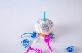 Cupcake with lite candle and ribbons on white background Royalty Free Stock Photo