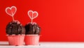 Cupcake love: Heart-themed treats on a vibrant red backdrop