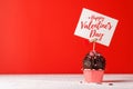Cupcake love: Heart-themed treats on a vibrant red backdrop