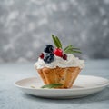 Cupcake muffin with blueberry and rosemary butter cream on a gray photo