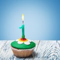 Cupcake with number one on a blue background Royalty Free Stock Photo