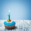 Cupcake with number one on a blue background Royalty Free Stock Photo