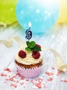 Cupcake with a numeral nine candle