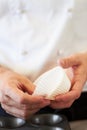 Cupcake, person hands and baking in a kitchen with muffin wrapper and cooking in a bakery. Prepare, paper cup and food