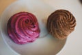 Cupcake with pink and brown cream, selective focus, close up