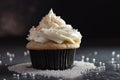 cupcake with piped swirl of frosting and sprinkling of sugar crystals