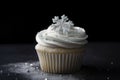 cupcake with piped swirl of frosting and sprinkling of sugar crystals