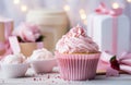 a cupcake is placed beside a gift box Royalty Free Stock Photo