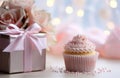 a cupcake is placed beside a gift box Royalty Free Stock Photo
