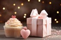 a cupcake is placed beside a gift box Royalty Free Stock Photo