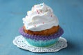 Cupcake with white cream icing and candy sprinkles Royalty Free Stock Photo