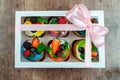 Cupcakes with berries in a gift box with a bow. Royalty Free Stock Photo